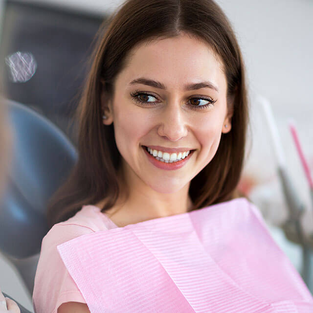 woman sitting in the dental chair smiling