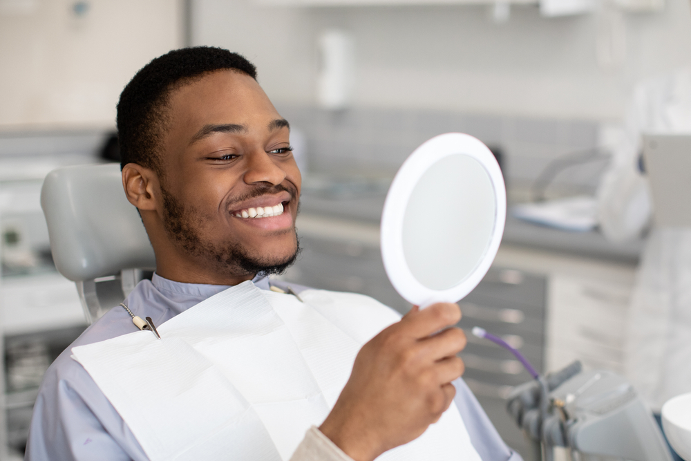 dental patient observing smile in mirror