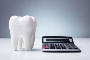 a calculator and fake tooth