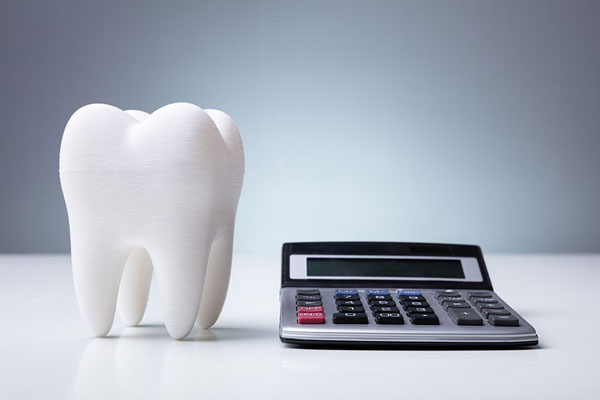 a calculator and fake tooth